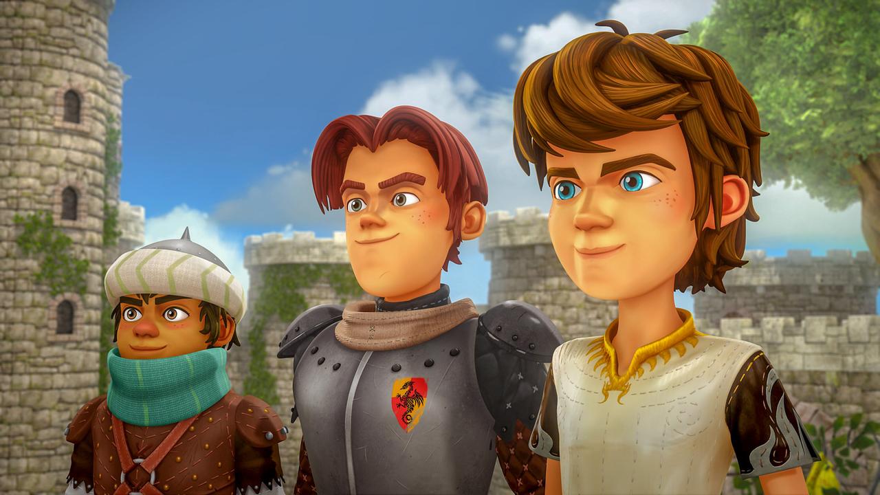Arthur steht mit zwei Freunden in der Nähe einer Burg. Ein Junge trägt eine Rüstung, der andere eine Kappe und einen Schal.