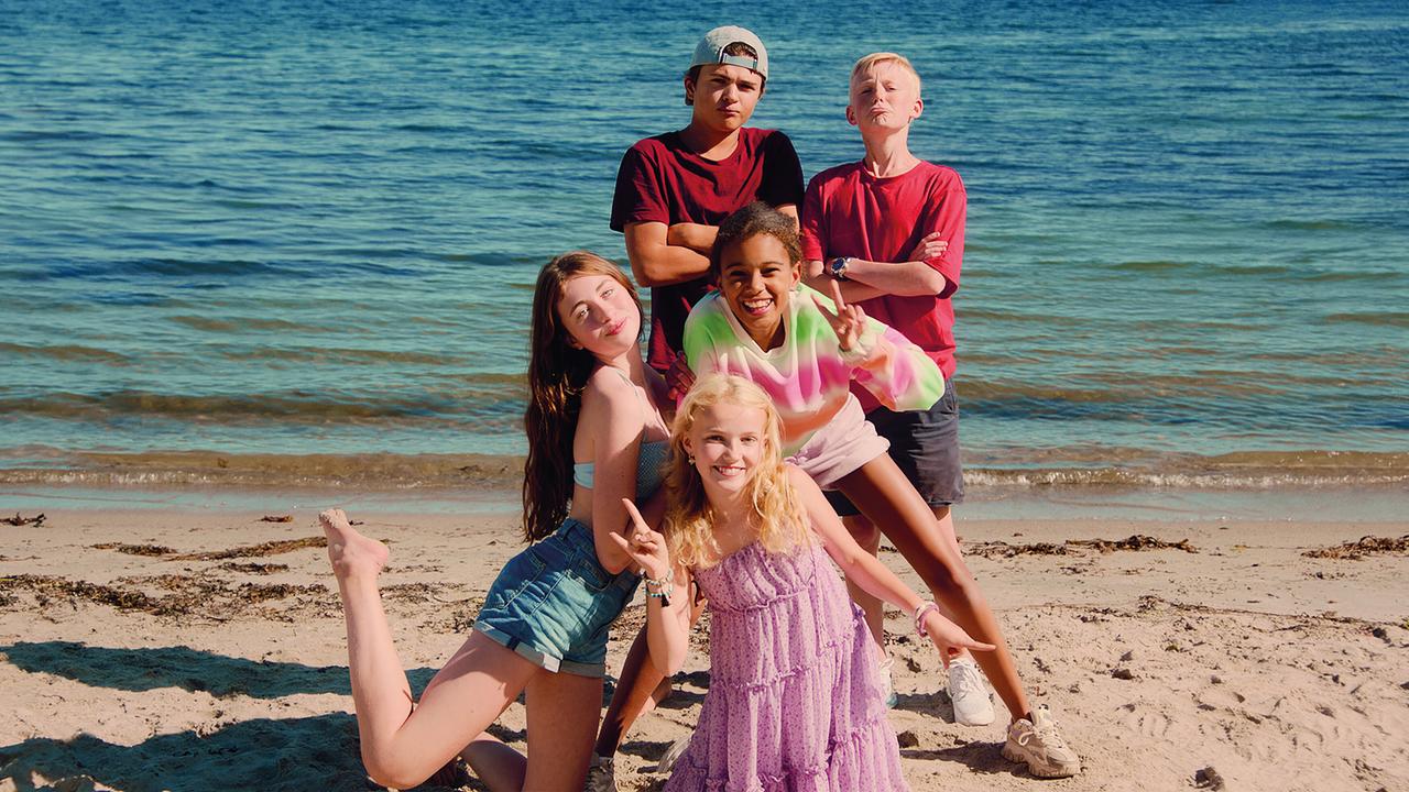 © ORF/Beta Film/NRK/Annicken Aasheim/Alvilde Naterstad Drei Jungs und drei Mädchen posieren am Strand, hinter ihnen ist das Meer.
