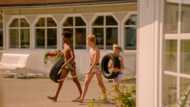 © ORF/Beta Film/NRK/Annicken Aasheim/Alvilde Naterstad Drei Burschen in Badehosen, sie tragen Autoreifen und Stöcke.