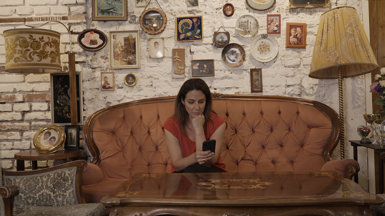 Lisa Gadenstätter sitzt auf einer Couch mit ihrem Handy in der Hand. Sie ist  in Greystones, Irland. 