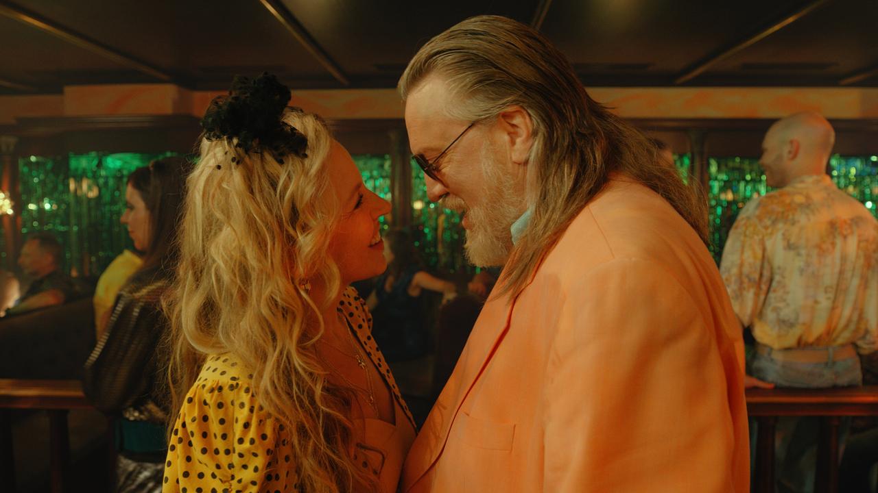 © ORF/Superfilm Elfi Pfeisinger und Richard Tschach stehen eng beieinander auf einer Tanzfläche in einem bunt beleuchteten Club.