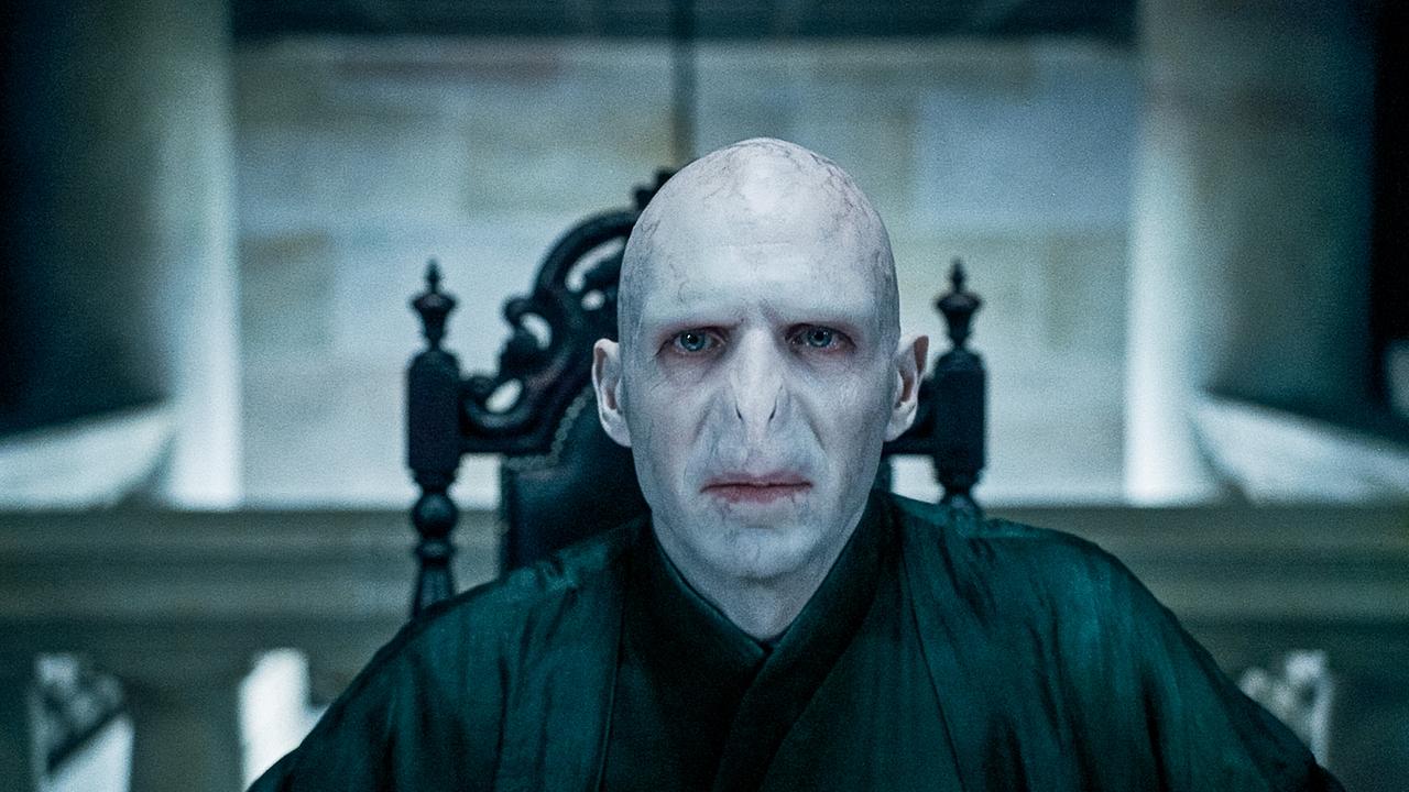 © ORF/Warner Bros. Pictures Ralph Fiennes als Lord Voldemort sitzt er mit bleichem Gesicht in einem schwarzen Mantel auf einem schwarzen Sessel und blickt direkt in die Kamera