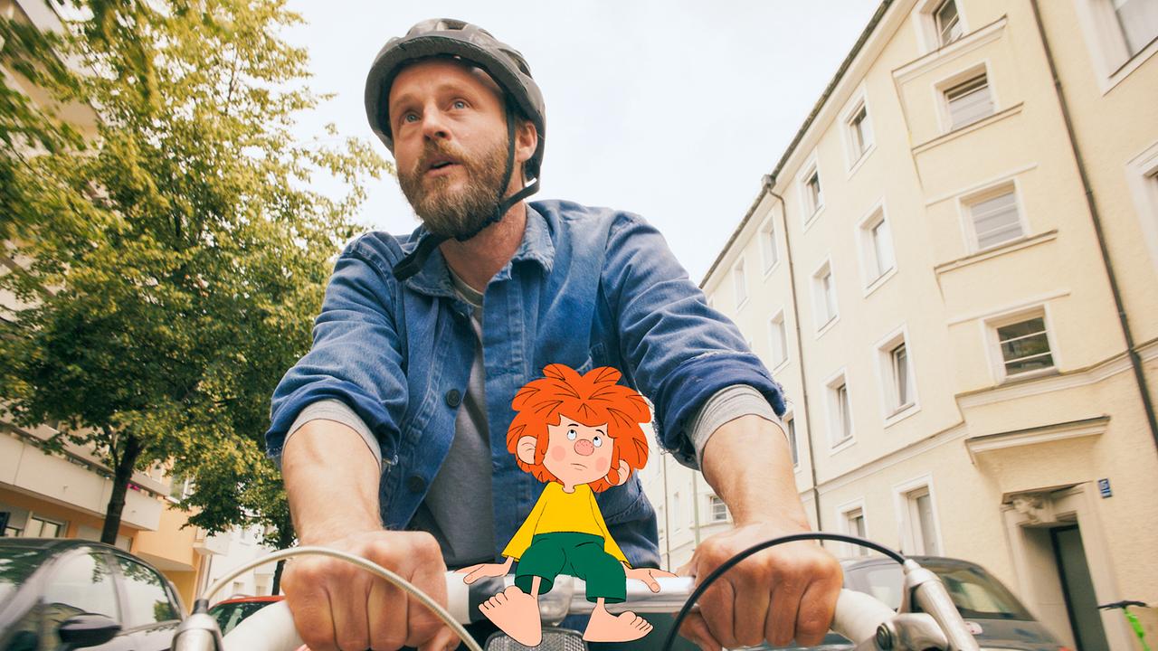 Meister Eder nimmt Pumuckl auf seinem Rad mit.