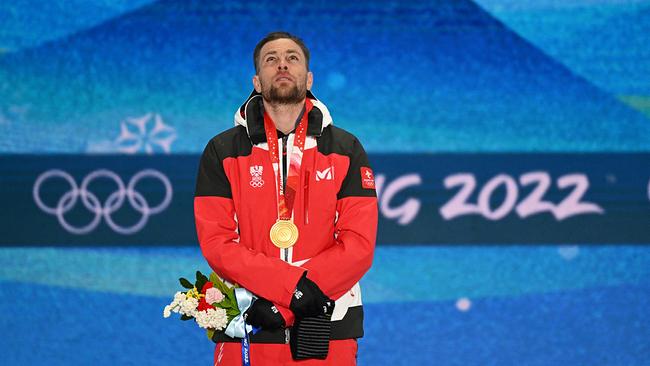 Gold medallist Austria's Benjamin Karl poses on the podium during the victory ceremony of the snowboard men's parallel giant slalom during the Beijing 2022 Winter Olympic Games at the Zhangjiakou Medals Plaza on February 8, 2022.