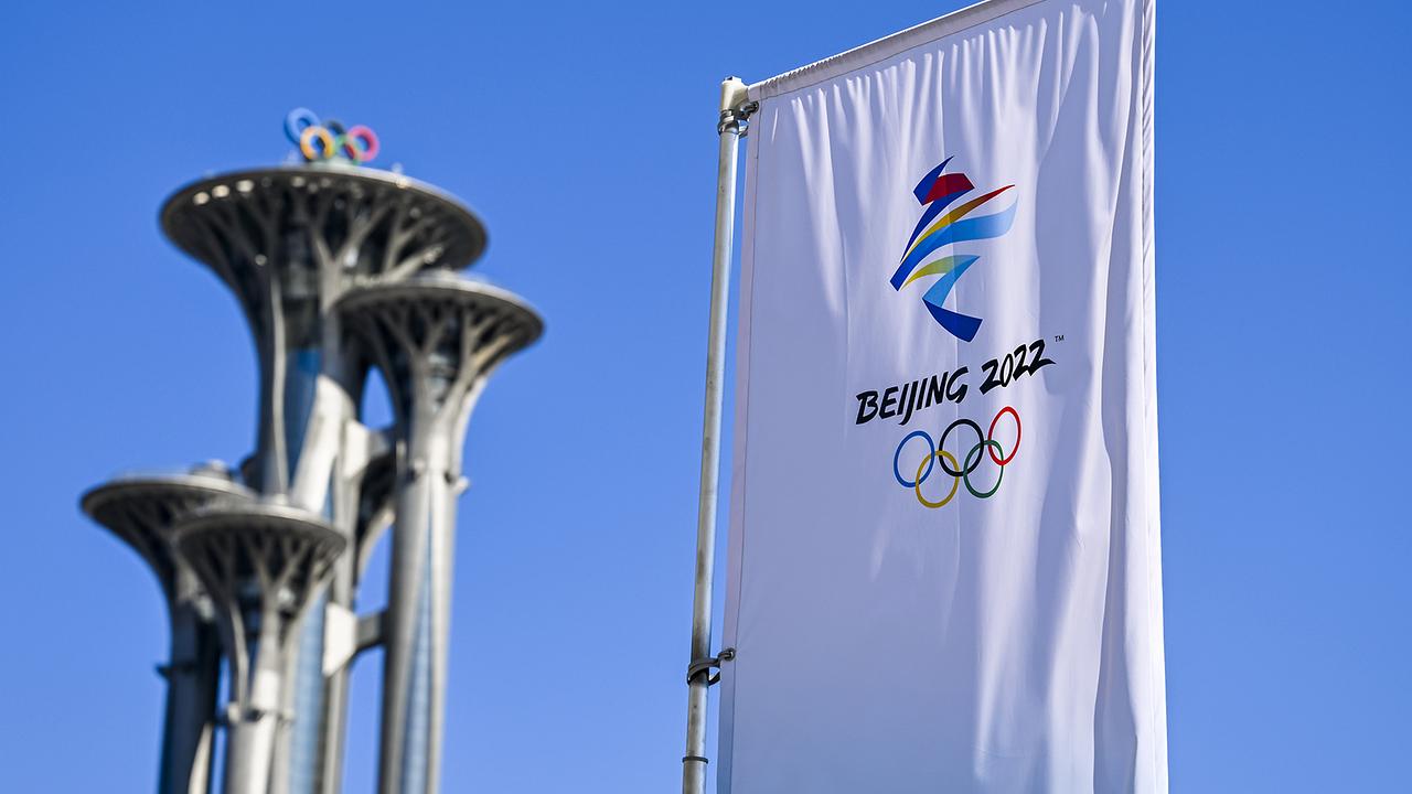 The Olympic Tower adorned with the Olympic Rings is seen  next to a flag at the entrance of the Main Media Centre (MMC) prior to the 2022 Winter Olympics in Beijing, China, on Wednesday, February 2, 2022
