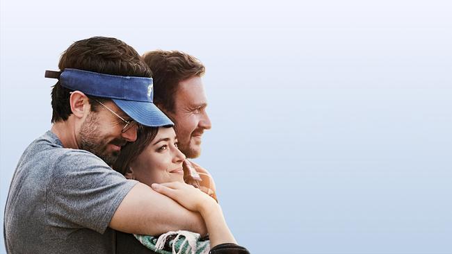 © ORF/Tobis Ein Mann mit Brille und Schirmkappe umarmt eine Frau, die sich an ihn anlehnt, neben dem Paar sitzt ein Mann, alle drei lächeln freundlich