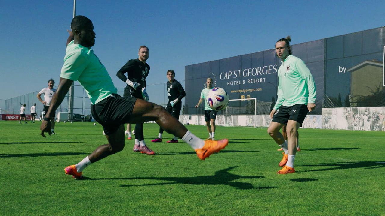 Kevin Danso, Patrick Wimmer und weitere Spieler im Teamcamp beim Training auf dem Platz im Freien.