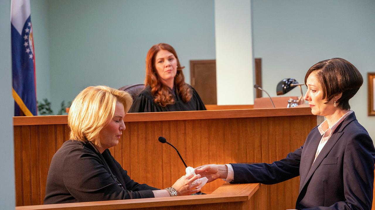 © ORF/Universal/NBC/Skip Bolen Beim Gerichtsprozess sitzt Pam Hupp im Zeugenstand, Anwältin Leah Askey steht ihr gegenüber und reicht ihr Taschentücher, hinter ihnen sitzt Richterin Mennemeyer und beobachtet die Szene