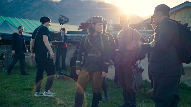 Am Set von "Mila/Marija": Eine Filmcrew arbeitet im Freien, während mehrere Darsteller in historischen Militäruniformen stehen.