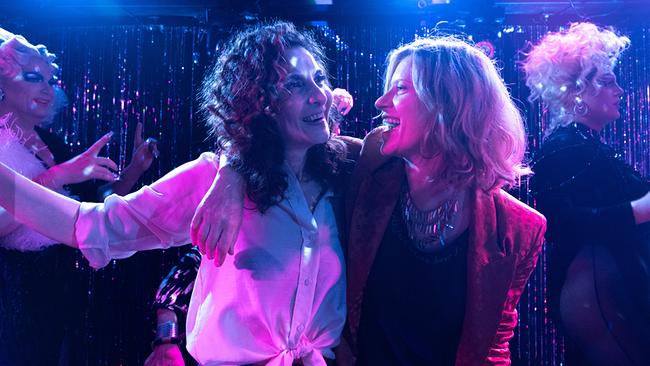 © ORF/Praherfilm/Nikolaus Geyrhalter Filmproduktion/Petro Domenigg Fa und Marie Theres stehen eng beieinander auf einer Tanzfläche, umgeben von weiteren Tanzenden und buntem Licht.