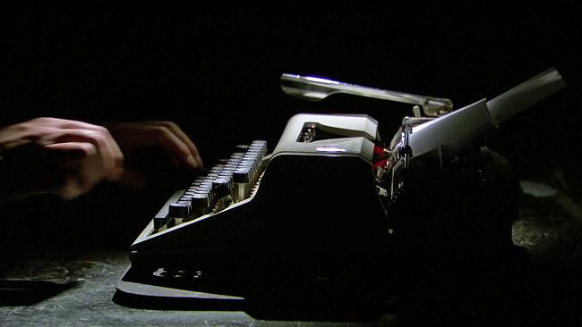 Hände tippen auf Tastatur einer alten Schreibmaschine