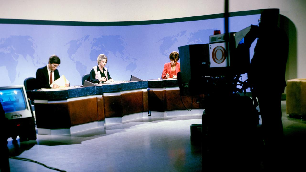 Heribert Queste und Ursula Stenzel sitzen im "Zeit im Bild"-Studio, während eine Kamera im Vordergrund auf sie gerichtet ist. (1980)