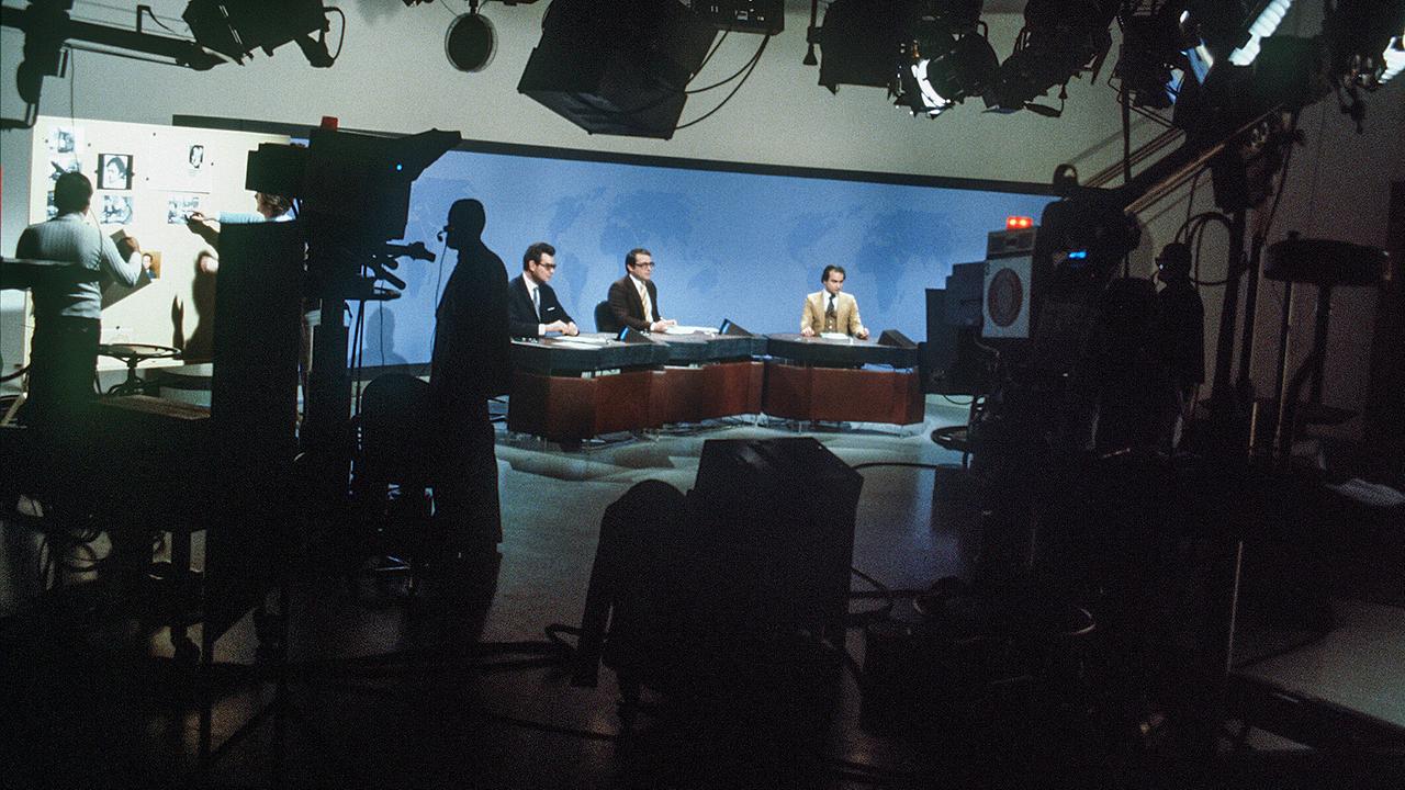 Wolfgang Riemerschmied, Günter Schmidt und Franz Zoglauer sitzen 1979 am Nachrichtentisch im "Zeit im Bild"-Studio o, umgeben von großen Kameras und Scheinwerfern.