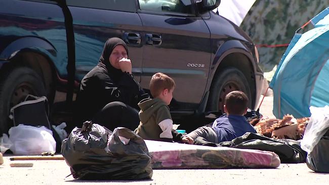 © ORF Eine Frau mit 2 kleinen Kindern sitzt auf dem Boden auf einer Matratze, vor ihnen 2 gefüllte Plasiksäcke