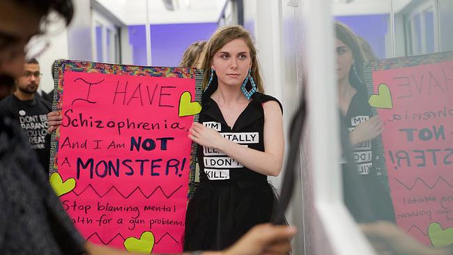 © ORF/Pangloss Films Cecilia McGough hält ein Plakat hoch, das für einen differenzierten Umgang mit Schizophrenie und gegen deren Stigmatisierung wirbt.