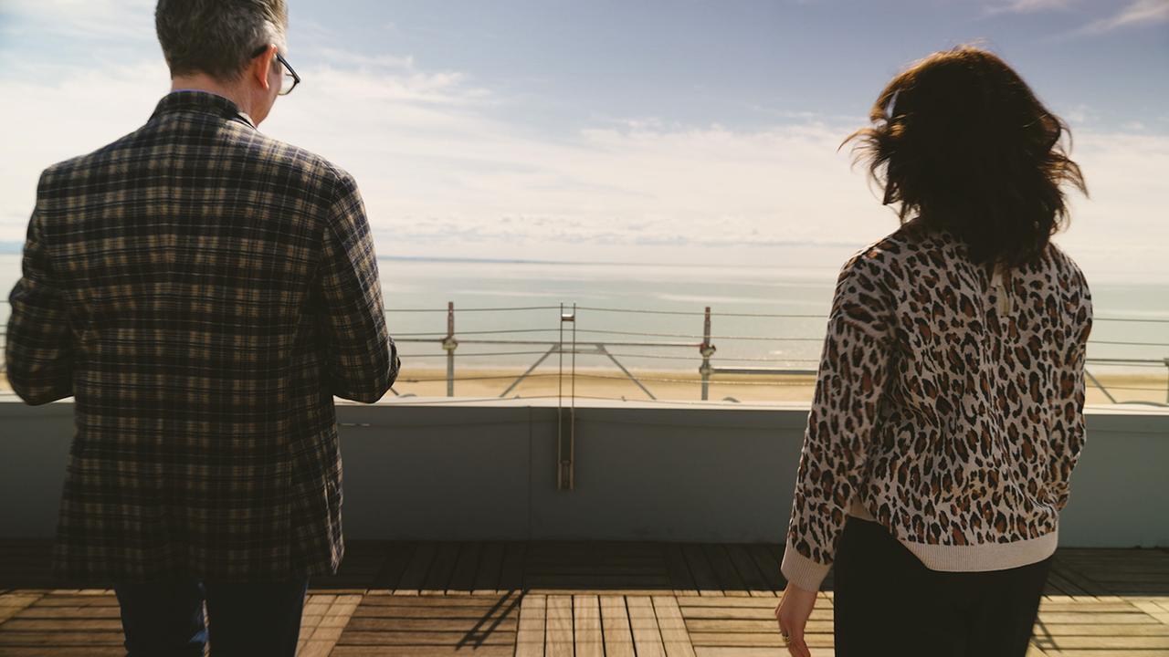 Julia Cencig im Gespräch mit Hotelier Pierre Francesco Bocus in Lignano blicken von einer Dachterrasse über das Meer.