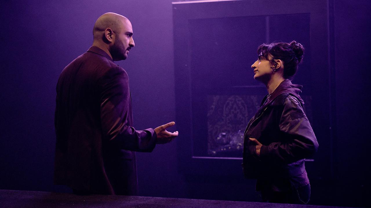 Reza Taremi und Ella Pauls führen in einem dunklen leeren Clubraum ein Gespräch.