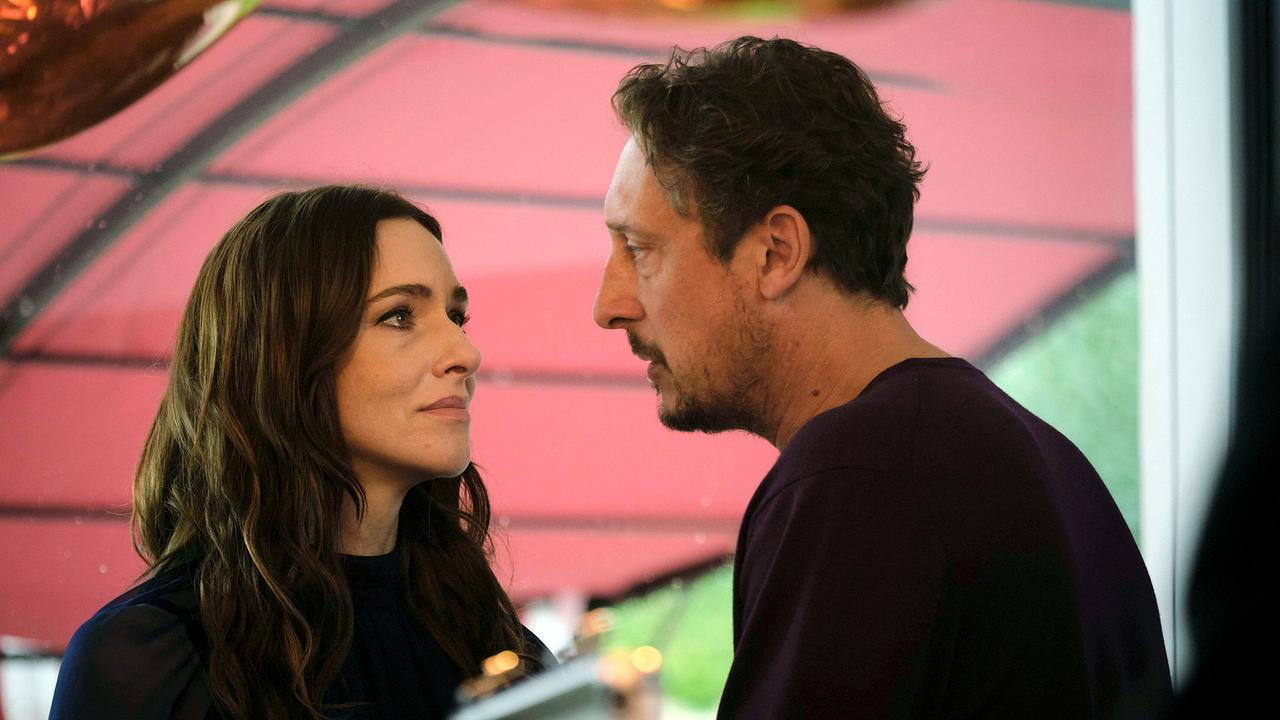 Pony und Stephan Hübner schauen sich in die Augen in einem Raum mit rotem Sonnenschutz.