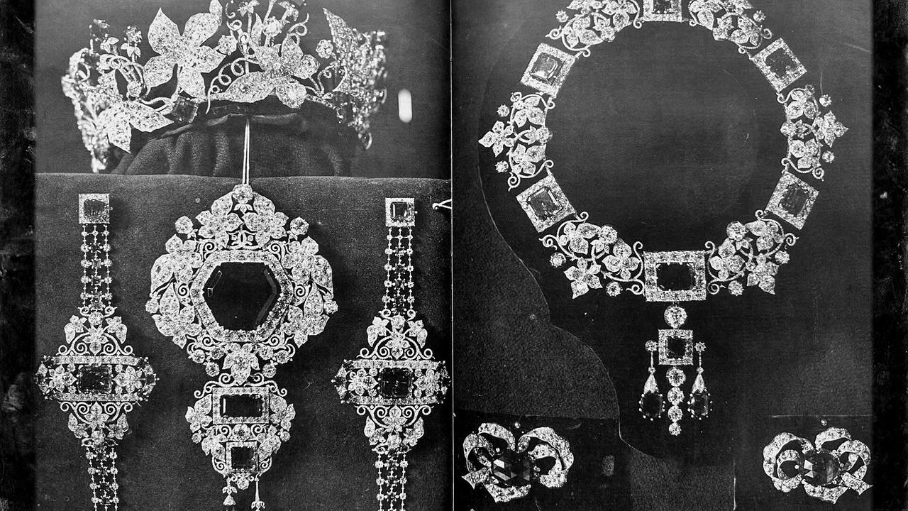 © ORF/Pammer Film Eine historische Schwarz-Weiß-Fotografie der kaiserliche Kronjuwelen aus Diamanten und großen rechteckigen Edelsteinen, bestehend aus Tiara, Halskette, Armbändern und Broschen.
