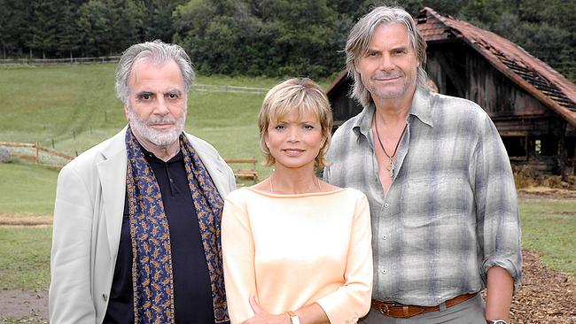 Maximilian Schell (Xaver Schönborn), Uschi Glas (Gundi Kirchner) und Peter Simonischek (Dr. Sigi Fürstberger) stehen auf der Almwiese vor einer Holzscheune.