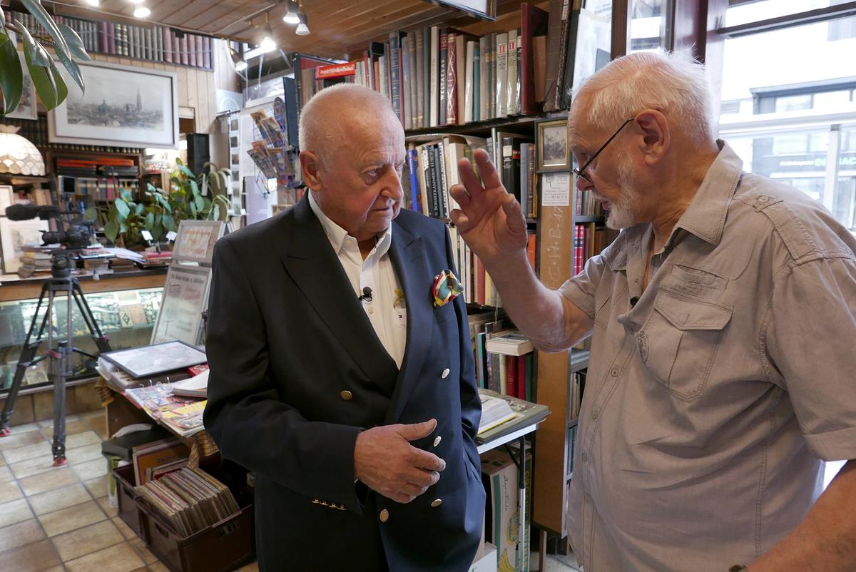© ORF_TV AND MORE Rudolf Klingohr und Antiquar Ernst Anzböck stehen in einem Raum mit vielen Büchern und sprechen über den Untergang der Linz.