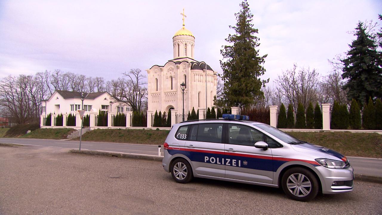 Kleine Kirche mit einem Polizeiauto davor. 
