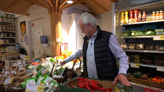 Willi hinter seinem Marktstand mit Gemüse.
