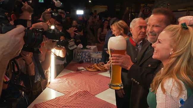 © ORF / Seitenblicke Arnold Schwarzenegger hält ein großes Glas Bier für die Fotografen in die Kameras