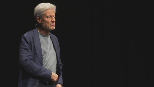 © ORF / Seitenblicke Florian Scheuba steht grantig schauend auf der Bühne, schwarzer Hintergrund