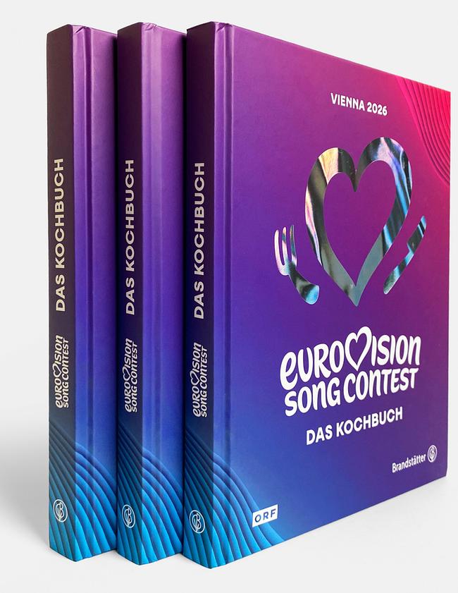 Drei nebeneinander stehende Exemplare des Buchs „Eurovision Song Contest – Das Kochbuch“ mit violett‑blauem Coverdesign für Wien 2026.