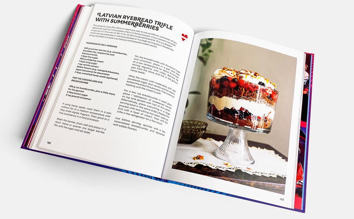 © ORF/Brandstätter An open book page with a dessert recipe and a large photo of the "Latvian Ryebread Trifle with Summerberries"