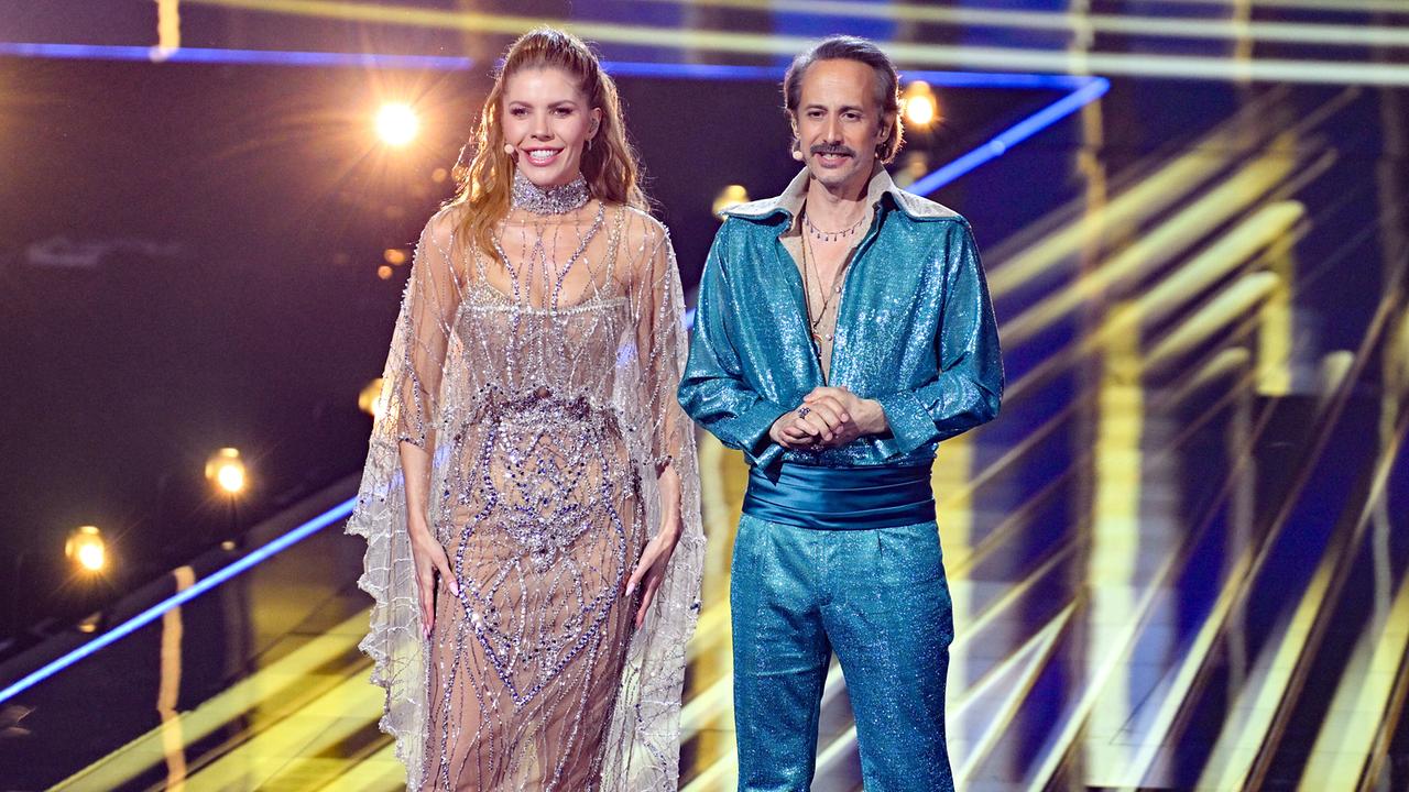 © ORF/Thomas Ramstorfer Victoria Swarovski and Michael Ostrowski during rehearsals for the Eurovision Song Contest Semifinal 2, on stage in front of a light and LED backdrop.