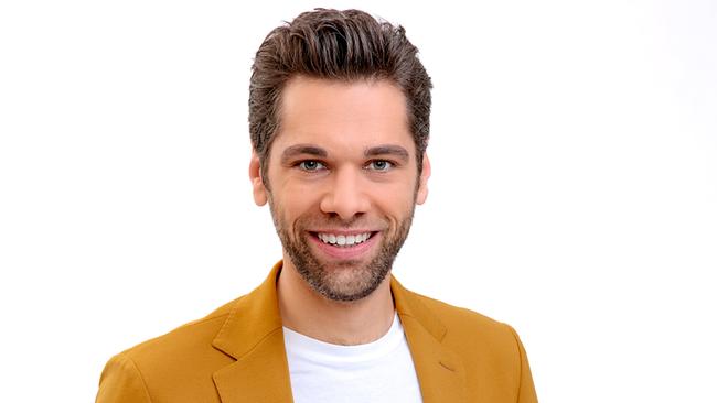 Philipp Maschl im senfgelben Anzug mit weißem T‑Shirt vor einem hellen, neutralen Hintergrund