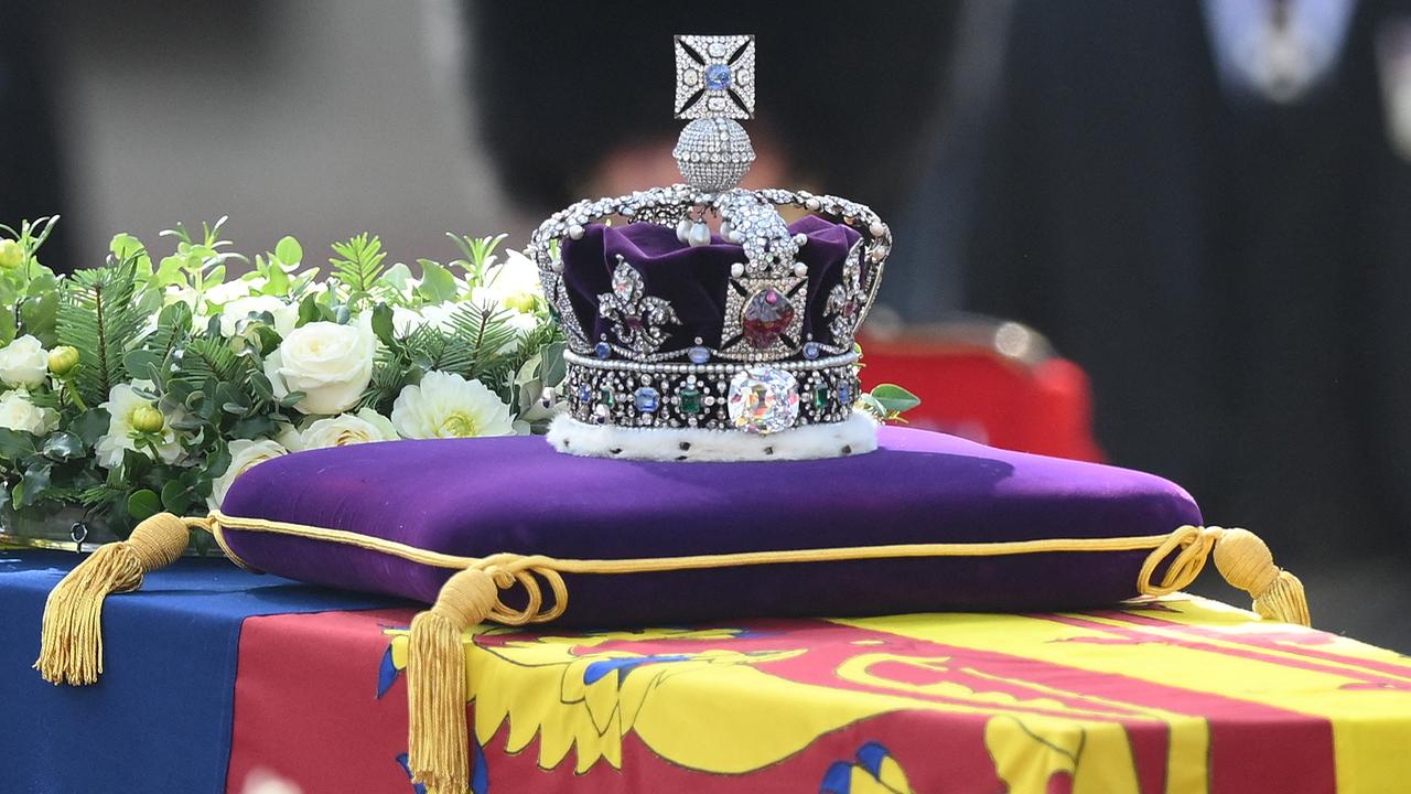 The coffin of Queen Elizabeth II, adorned with a Royal Standard and the Imperial State Crown is pulled by a Gun Carriage of The King's Troop Royal Horse Artillery, during a procession from Buckingham Palace to the Palace of Westminster, in London on September 14, 2022. Queen Elizabeth II will lie in state in Westminster Hall inside the Palace of Westminster, from Wednesday until a few hours before her funeral on Monday, with huge queues expected to file past her coffin to pay their respects.