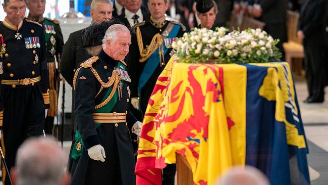 Britain's King Charles III (C), Vice Admiral Timothy Laurence (L), Britain's Prince Andrew (3L), Britain's Prince Edward, Earl of Wessex (C) and Britain's Sophie, Countess of Wessex (centre R) walk past the coffin of Queen Elizabeth II, inside St Giles Cathedral in Edinburgh on September 12, 2022, during a service of Thanksgiving for the Queen's life. Mourners will on Monday get the first opportunity to pay respects before the coffin of Queen Elizabeth II, as it lies in an Edinburgh cathedral where King Charles III will preside over a vigil. 