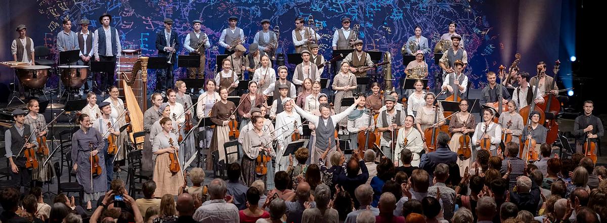 © ORF/ORF Landesstudio Steiermark mit Steirische Kulturveranstaltungen GmbH/Nikola Milatovic Das Styriarte Youth Orchestra und Mei-Ann Chen nehmen nach einem Konzert den Applaus des Publikums entgegen.